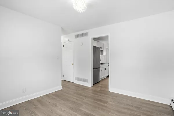 a view of an empty room with wooden floor