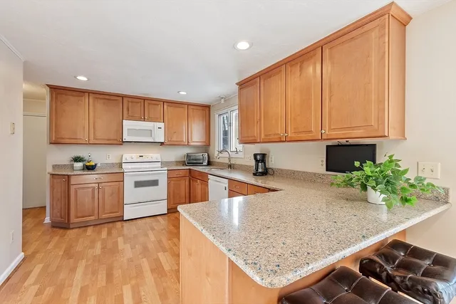 a kitchen with stainless steel appliances granite countertop a stove a sink and a microwave