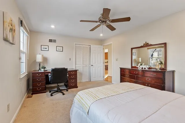 a bedroom with a bed and a chair