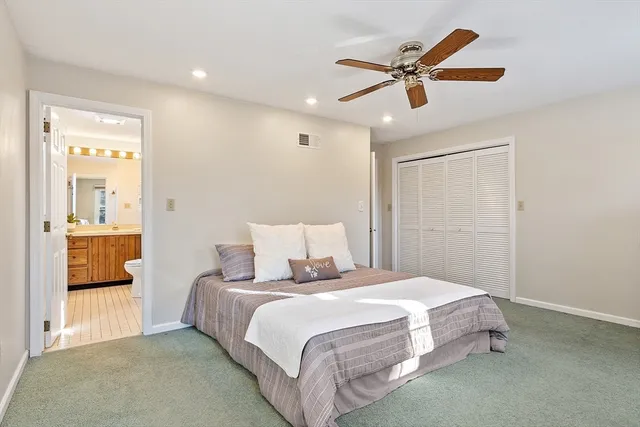 a bathroom with a granite countertop sink toilet a mirror a vanity and shower