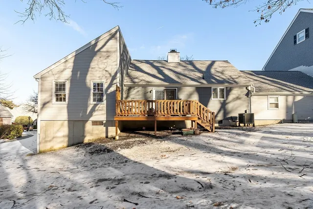 a front view of a house with a yard covered in snow