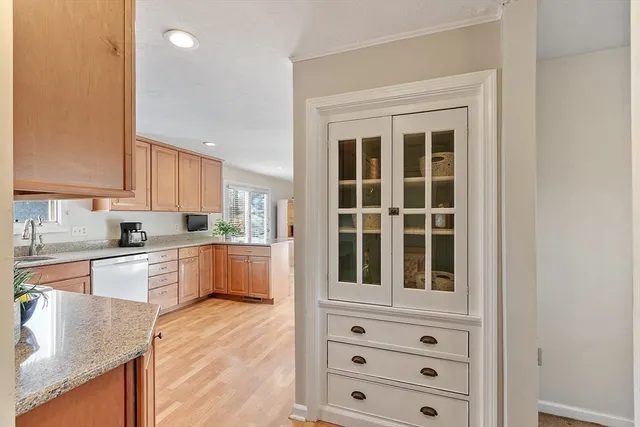a kitchen with granite countertop cabinets and window