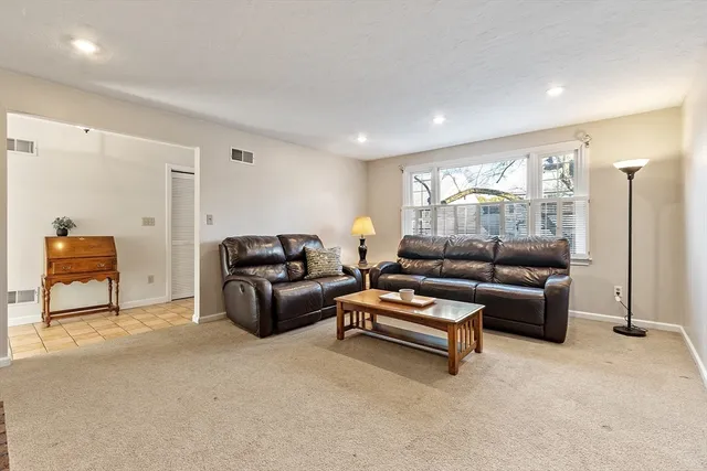 a living room with furniture and a lamp