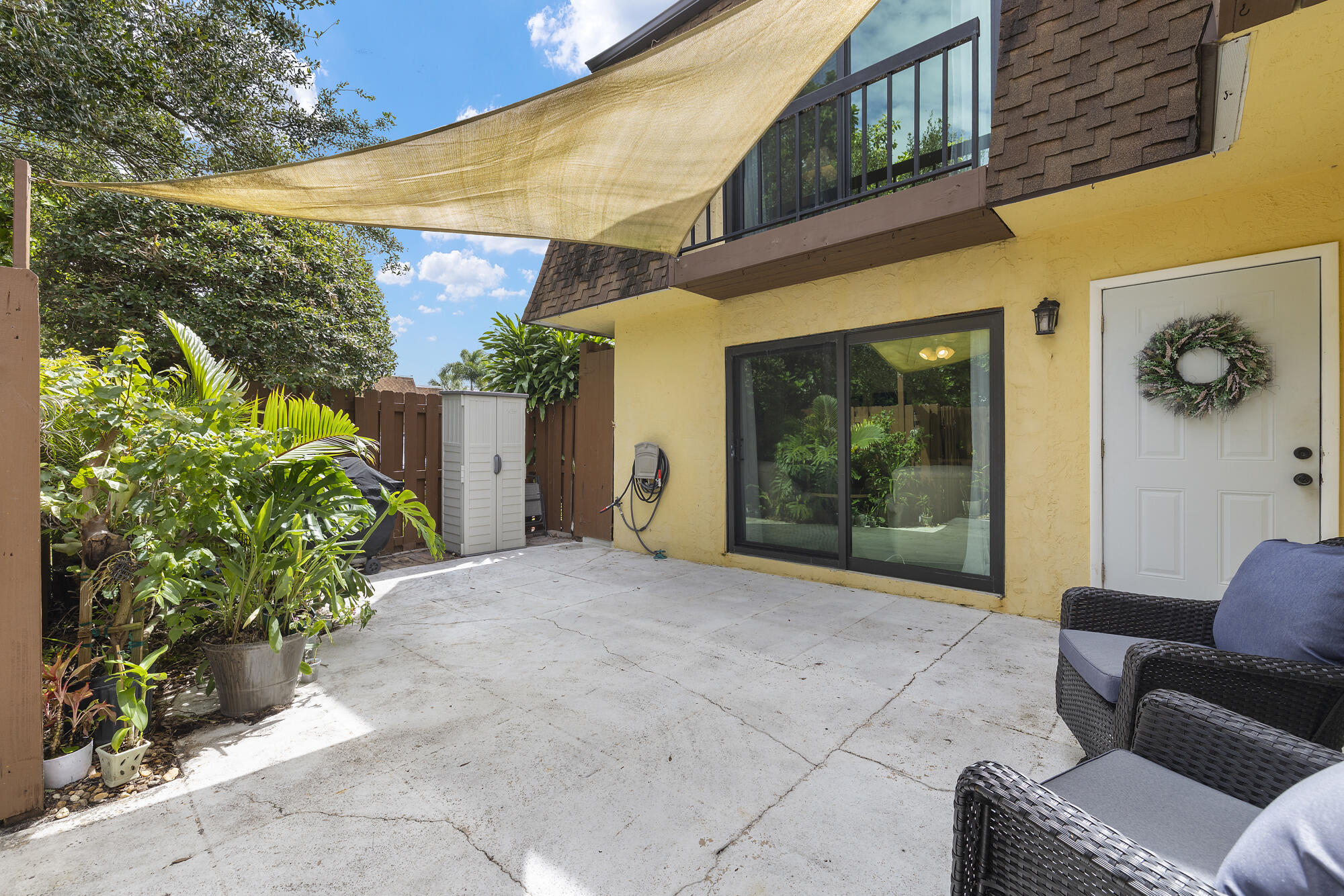 a view of backyard with outdoor seating and plants