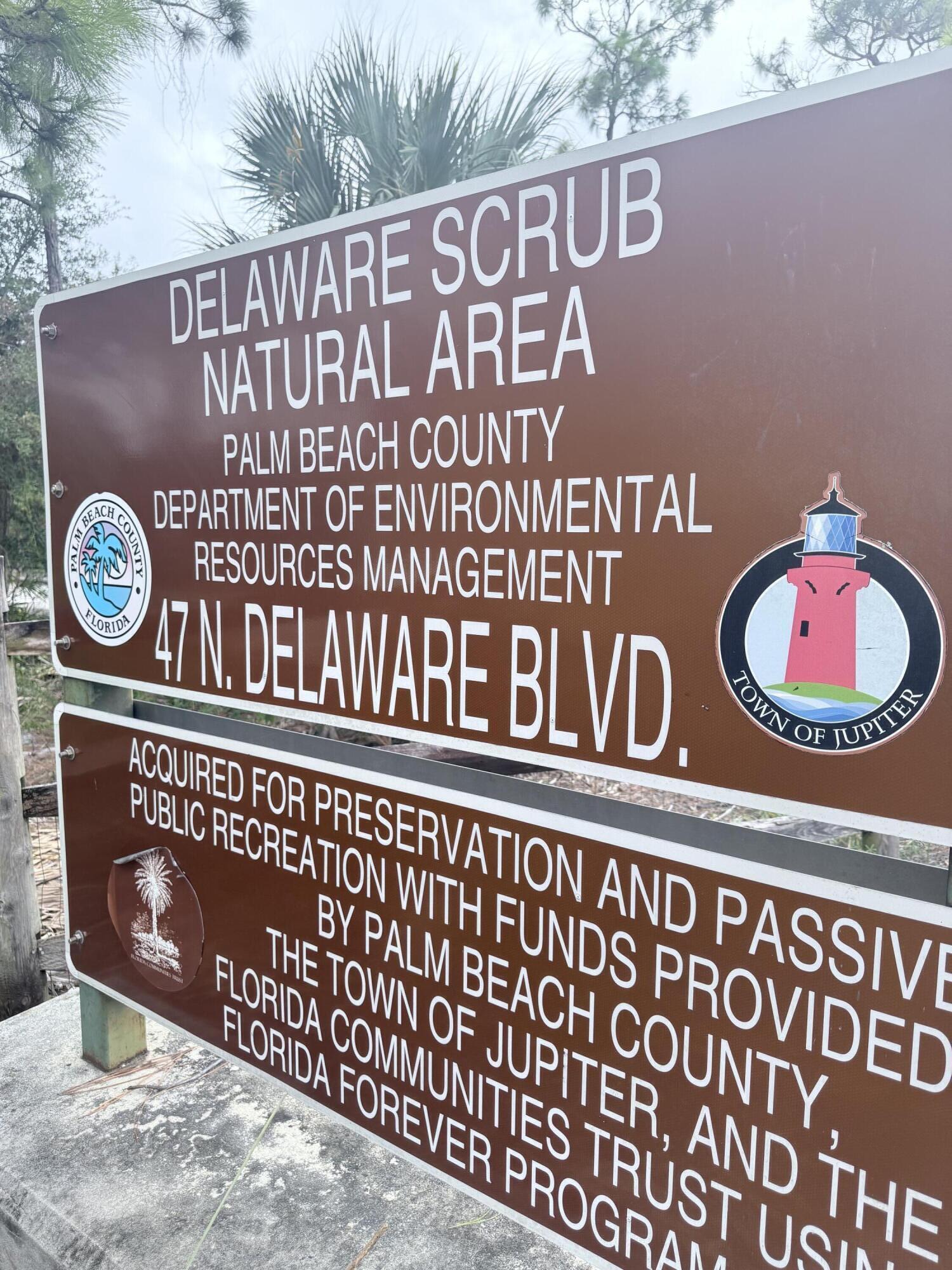 110 North Delaware Boulevard, Unit 18A Jupiter, FL 33458 - Photo 29 of 30 a sign on the side of a building