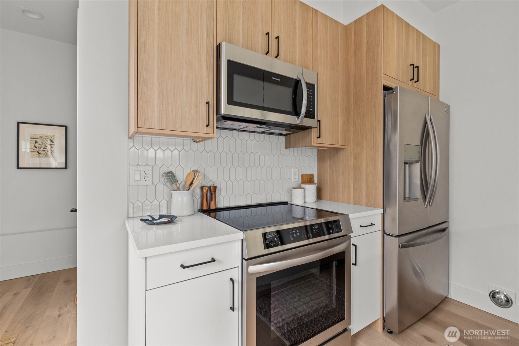 8405 42nd Avenue Southwest Seattle, WA 98136 - Photo 11 of 34 a kitchen with stainless steel appliances white cabinets and a stove top oven