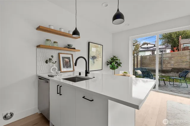 a kitchen with stainless steel appliances granite countertop a sink and a refrigerator