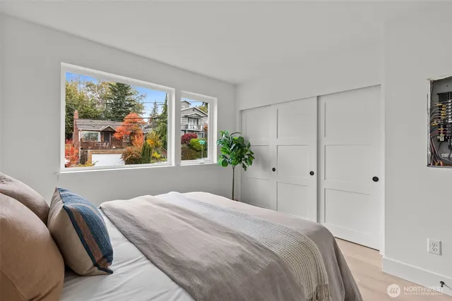 a bedroom with a large bed and a large window