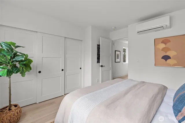 a bedroom with a bed and a potted plant