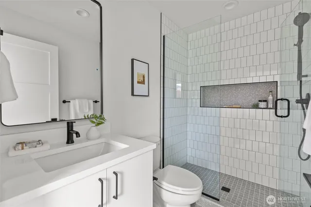 a bathroom with a sink toilet and shower