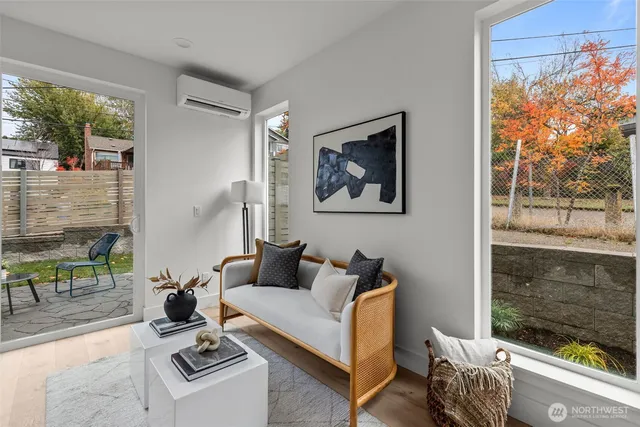 a living room with furniture a window and a painting on the wall