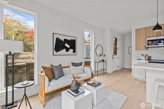 a living room with furniture a rug and white walls