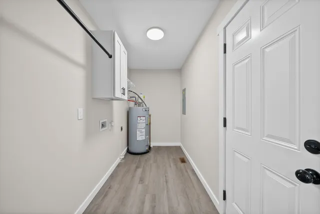 a view of hallway with stairs and wooden floor