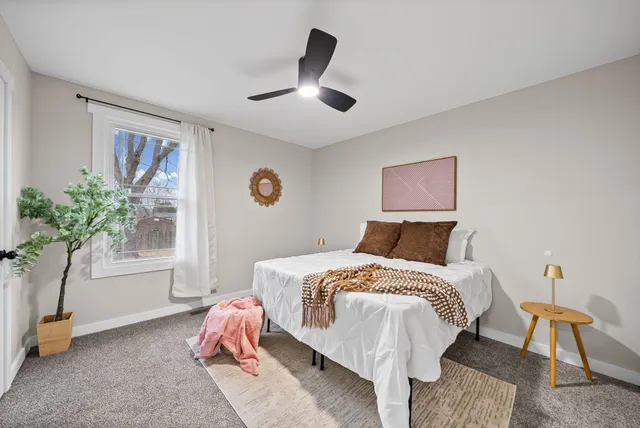 a bed room with a bed and a window