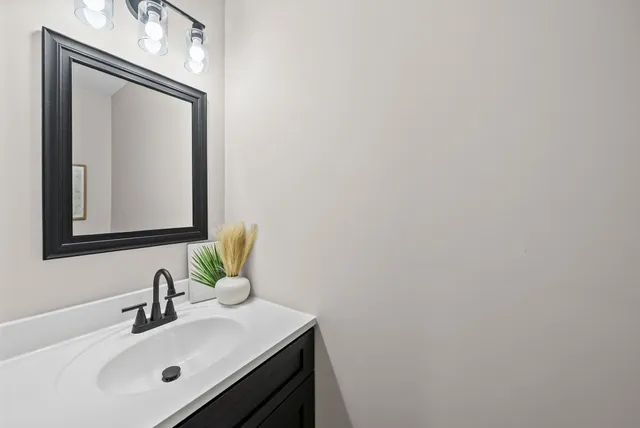 a bathroom with a sink vanity and a mirror
