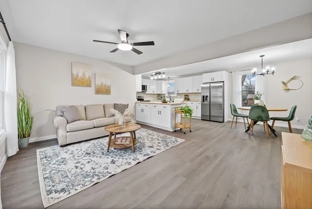 a living room with furniture and kitchen view