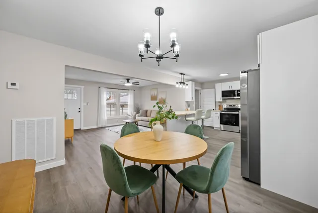 a view of a dining room with furniture and wooden floor