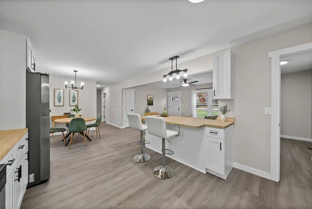 a view of a dining room with furniture and wooden floor