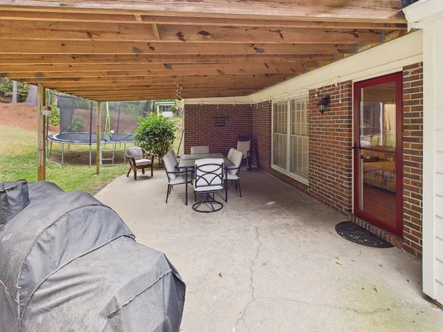 a view of a patio with table and chairs potted plants with wooden floor