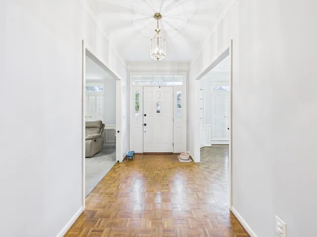 a view of a hallway with a chandelier