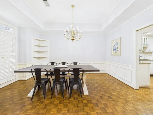 a view of a dining room with furniture and chandelier