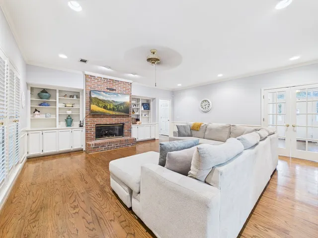 a living room with furniture a fireplace and a flat screen tv