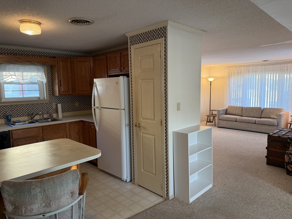 5 Virginia Avenue Marlborough, MA 01752 - Photo 19 of 19 a kitchen with stainless steel appliances granite countertop a refrigerator a stove and a sink with wooden floors