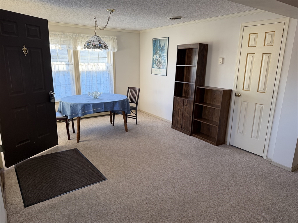 5 Virginia Avenue Marlborough, MA 01752 - Photo 5 of 19 an empty room with chandelier fan and wooden floor