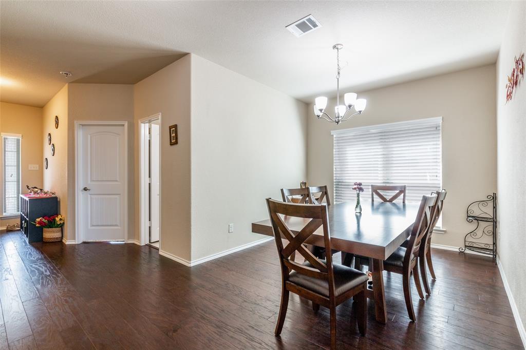 504 Rocky Pine Road McKinney, TX 75072 - Photo 10 of 36 Dining room featuring dark wood-style floors and a chandelier