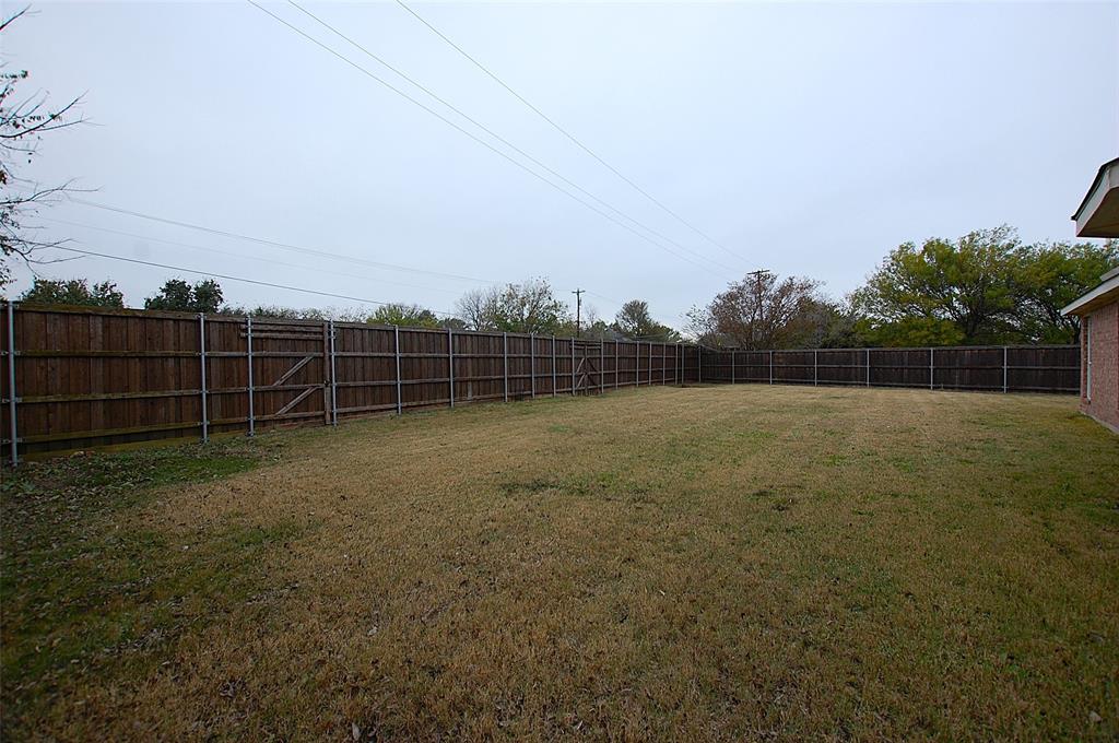 122 Princeton Circle Forney, TX 75126 - Photo 17 of 17 a view of a yard with a wooden fence