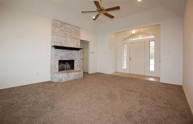 a view of empty room with fireplace