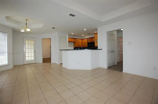 a view of a kitchen with a refrigerator and a window