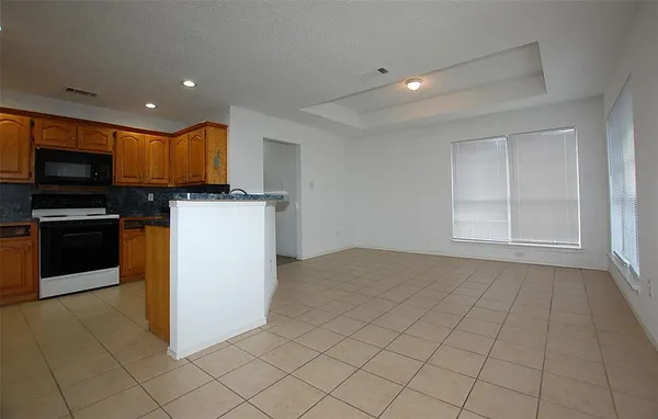 a kitchen with a sink a microwave and cabinets