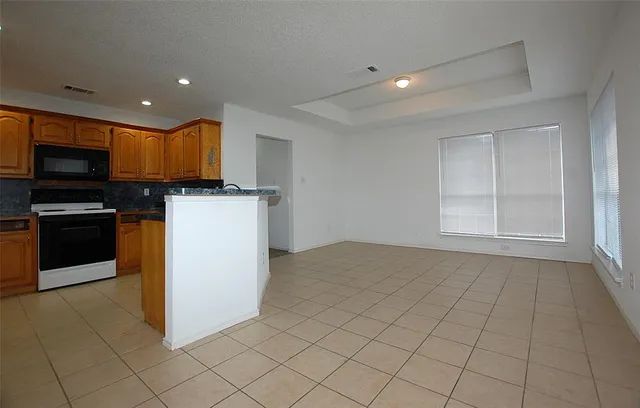 a kitchen with a sink a microwave and cabinets