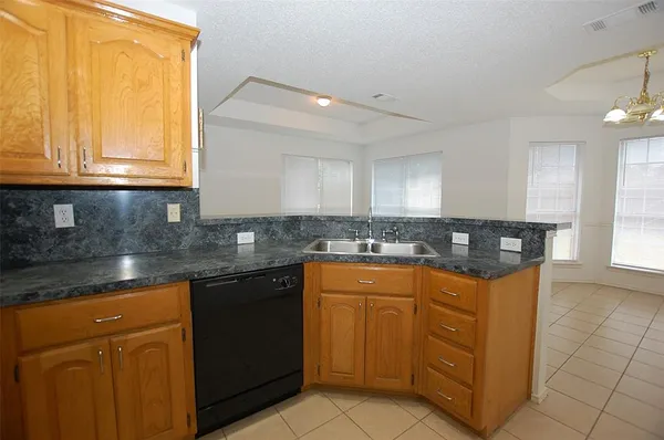 a kitchen with stainless steel appliances granite countertop a sink and a stove