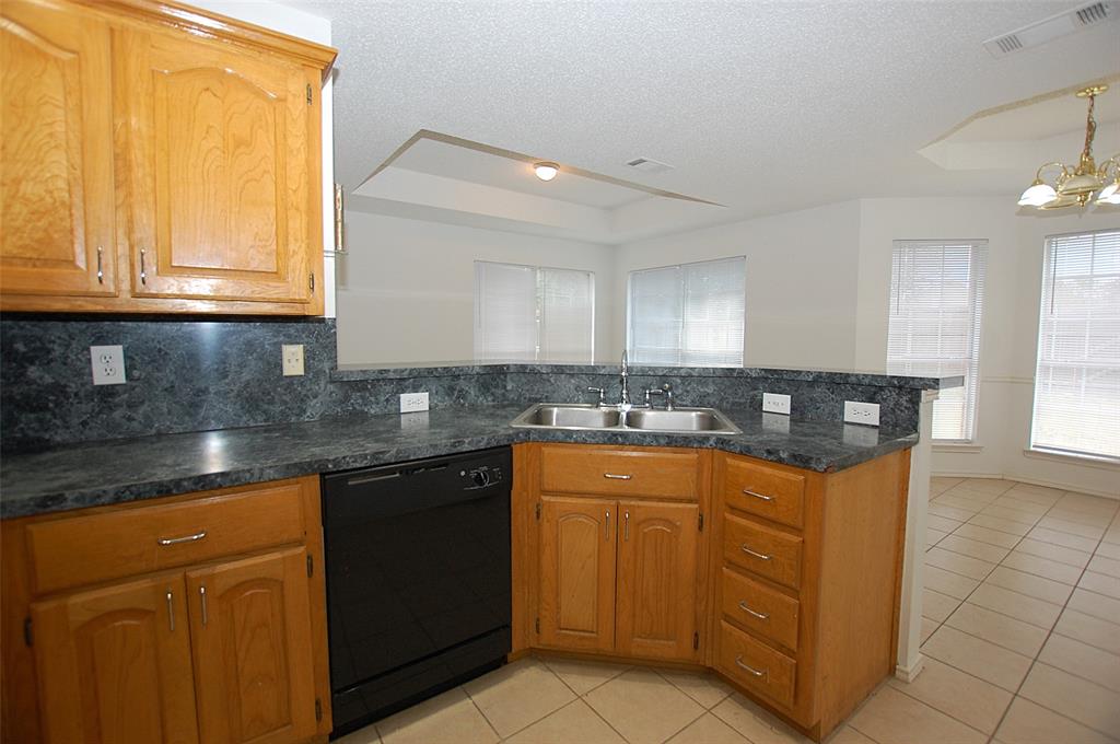 122 Princeton Circle Forney, TX 75126 - Photo 7 of 17 a kitchen with stainless steel appliances granite countertop a sink and a stove