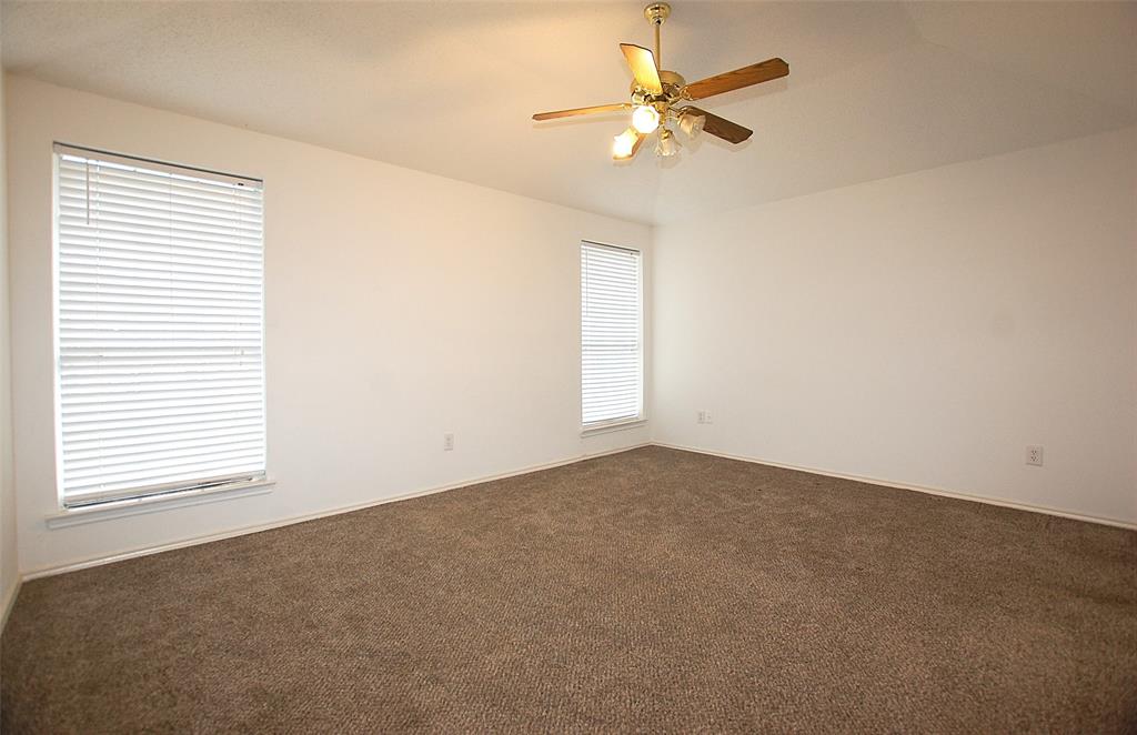 122 Princeton Circle Forney, TX 75126 - Photo 9 of 17 an empty room with windows and fan
