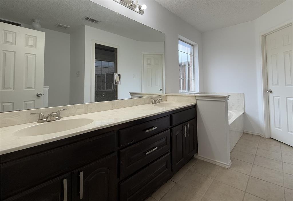 122 Princeton Circle Forney, TX 75126 - Photo 10 of 17 a bathroom with a double vanity sink and mirror