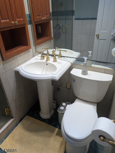 178 East Lindsley Road, Unit 2 Cedar Grove, NJ 07009 - Photo 20 of 28 a bathroom with a toilet sink and mirror