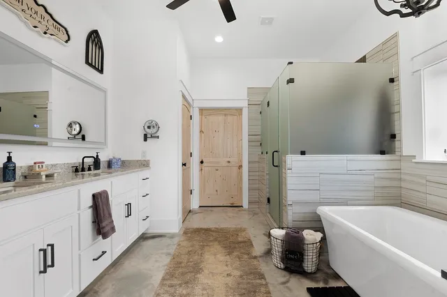 a bathroom with a tub sink a toilet and shower