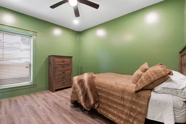 a bedroom with a bed and a chandelier