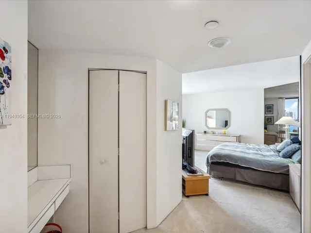 a bedroom with a bed and a lamp