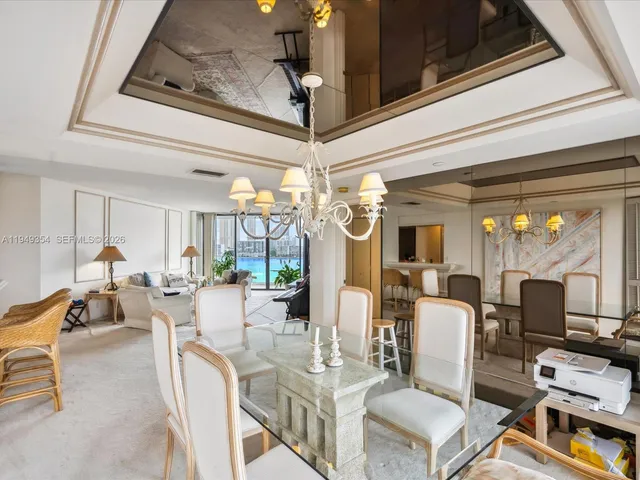 a view of a dining room with furniture wooden floor and chandelier