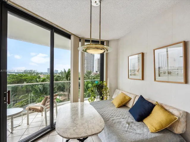 a living room with couch and a floor to ceiling window