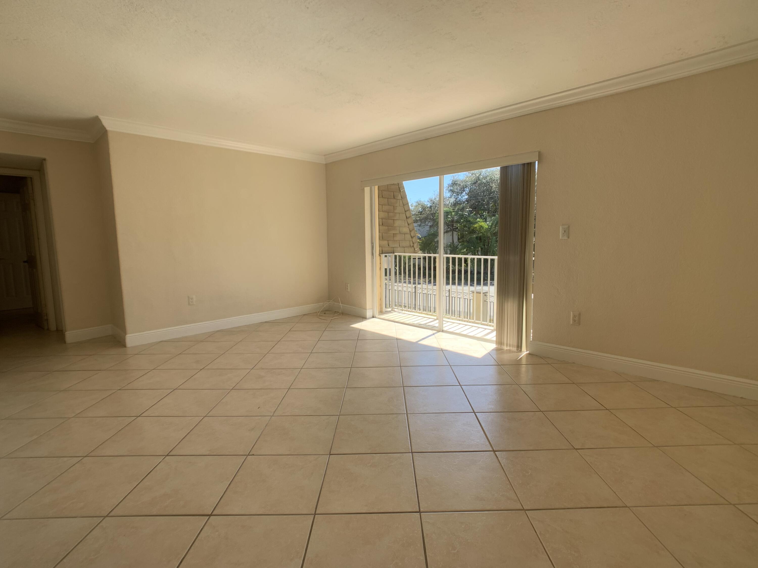 8601 Southwest 94th Street, Unit 201W Miami, FL 33156 - Photo 3 of 14 a view of an empty room with a window