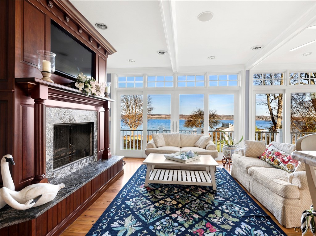 1818 West Lake Road Skaneateles, NY 13152 - Photo 24 of 48 Kitchen Sitting Area with granite surround Firepla