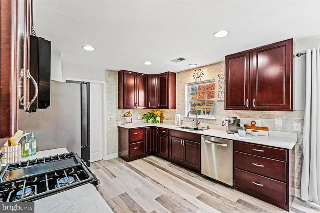 a kitchen with stainless steel appliances kitchen island granite countertop a sink and cabinets