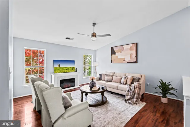 a living room with fireplace furniture and a wooden floor