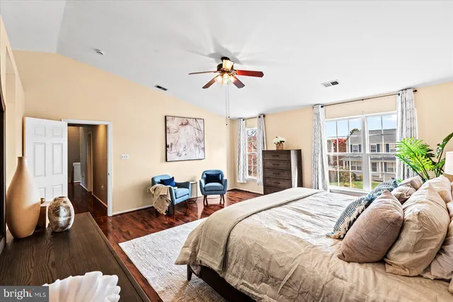 a bathroom with a granite countertop bathtub a sink and a large mirror