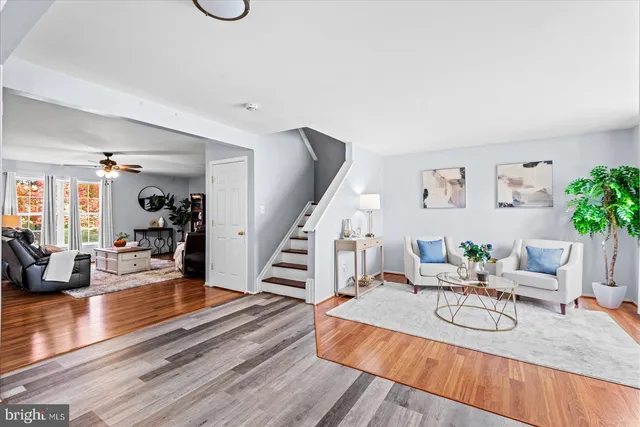 a living room with furniture potted plant and a window